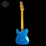 Blue electric guitar with a visible brand logo on a black background