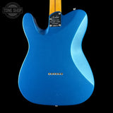Blue electric guitar body with brand logo on a black background