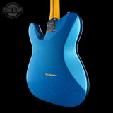 Blue electric guitar body with a black background