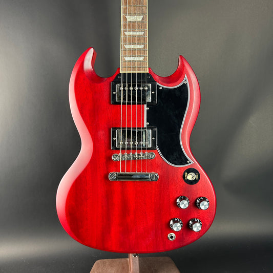 Red electric guitar on a gray background
