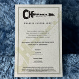 Charvel Custom Shop certificate on a textured blue surface