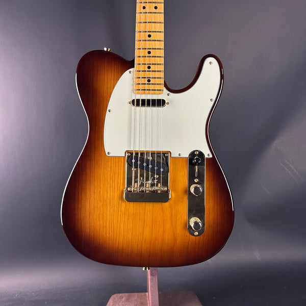 Electric guitar with a sunburst finish on a gray background