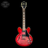 Red electric guitar on a black background with 'Tone Shop' logo.