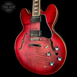 Red electric guitar with a black background