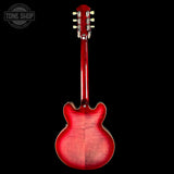 Red electric guitar headstock on a black background with 'Tone Shop' logo.