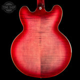 Red electric guitar body with a visible brand logo in the corner.