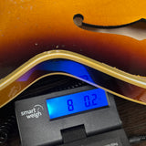 Gibson Custom 1959 ES-355 Bourbon Burst Heavy Aged on scale displaying weight.
