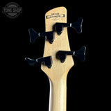 Guitar headstock with tuning pegs on a black background, featuring the Tone Shop logo.