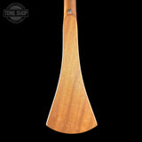 A wooden paddle or spoon-like tool with a smooth, tapered wooden head and a short handle, shown against a solid black background. A circular 'TONE SHOP' watermark is visible in the top-left corner.