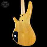 Wooden electric guitar body with a visible brand logo in the corner.