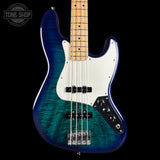 A four-string bass guitar with a vibrant blue and green flame maple finish, a white pickguard, and a natural maple neck, shown against a solid black background.