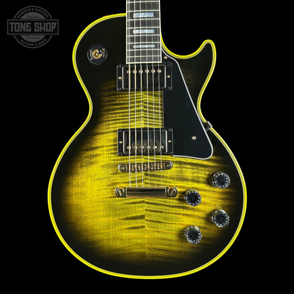 Electric guitar with a black and yellow finish on a black background, featuring the Tone Shop logo.