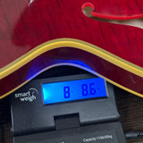 Gibson Custom 1959 ES-355 Figured Dark Viking Red Ultra Light Aged on scale displaying weight.