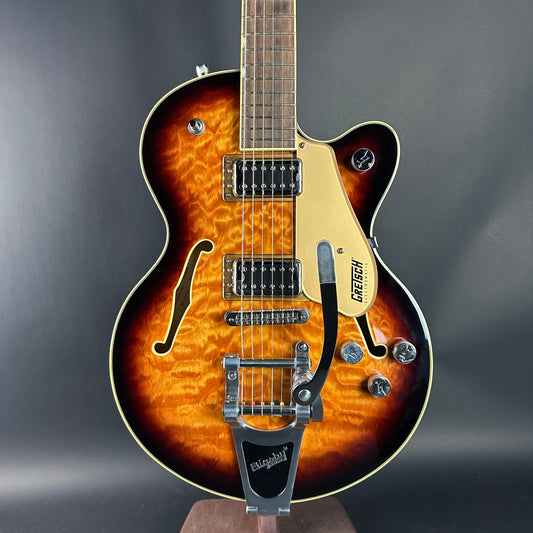 Electric guitar with a sunburst finish on a dark gray background