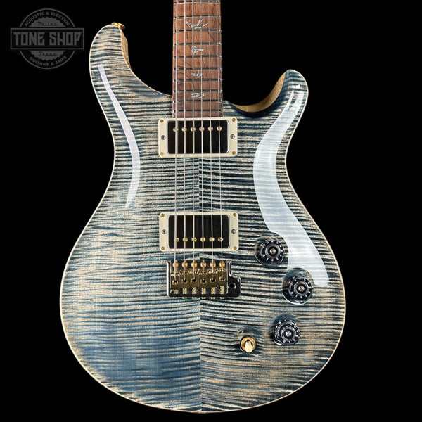 Electric guitar with a blue and white pattern on a black background, featuring the Tone Shop logo.