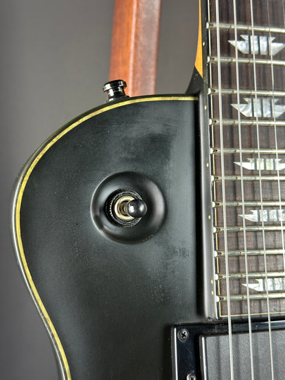 Close-up of an electric guitar's body with a focus on the pickup and neck