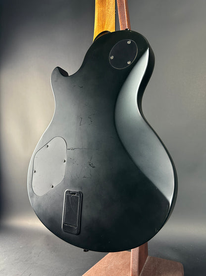 Close-up of a guitar's back with a dark gray background
