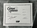 Certificate of Authenticity for an ESP guitar on a textured surface