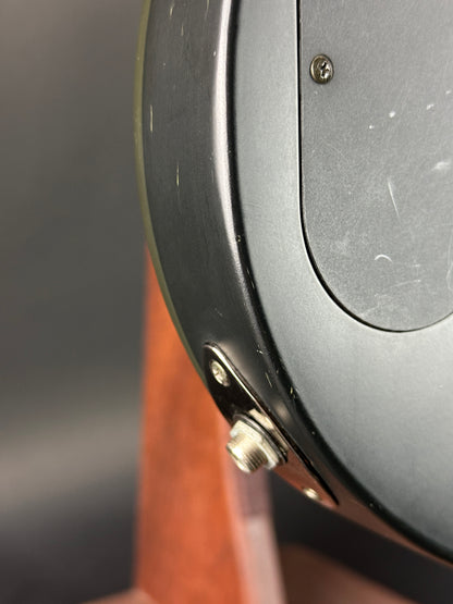 Close-up of a metallic object with a brown handle on a dark background