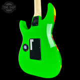 Green electric guitar with a colorful pickguard on a black background, featuring 'Tone Shop' branding.