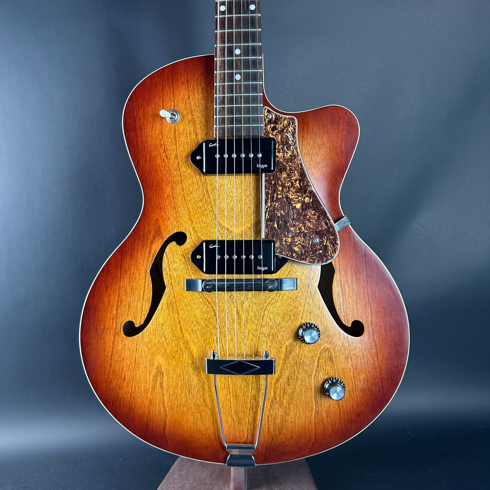 Wooden guitar with a dark blue gradient background