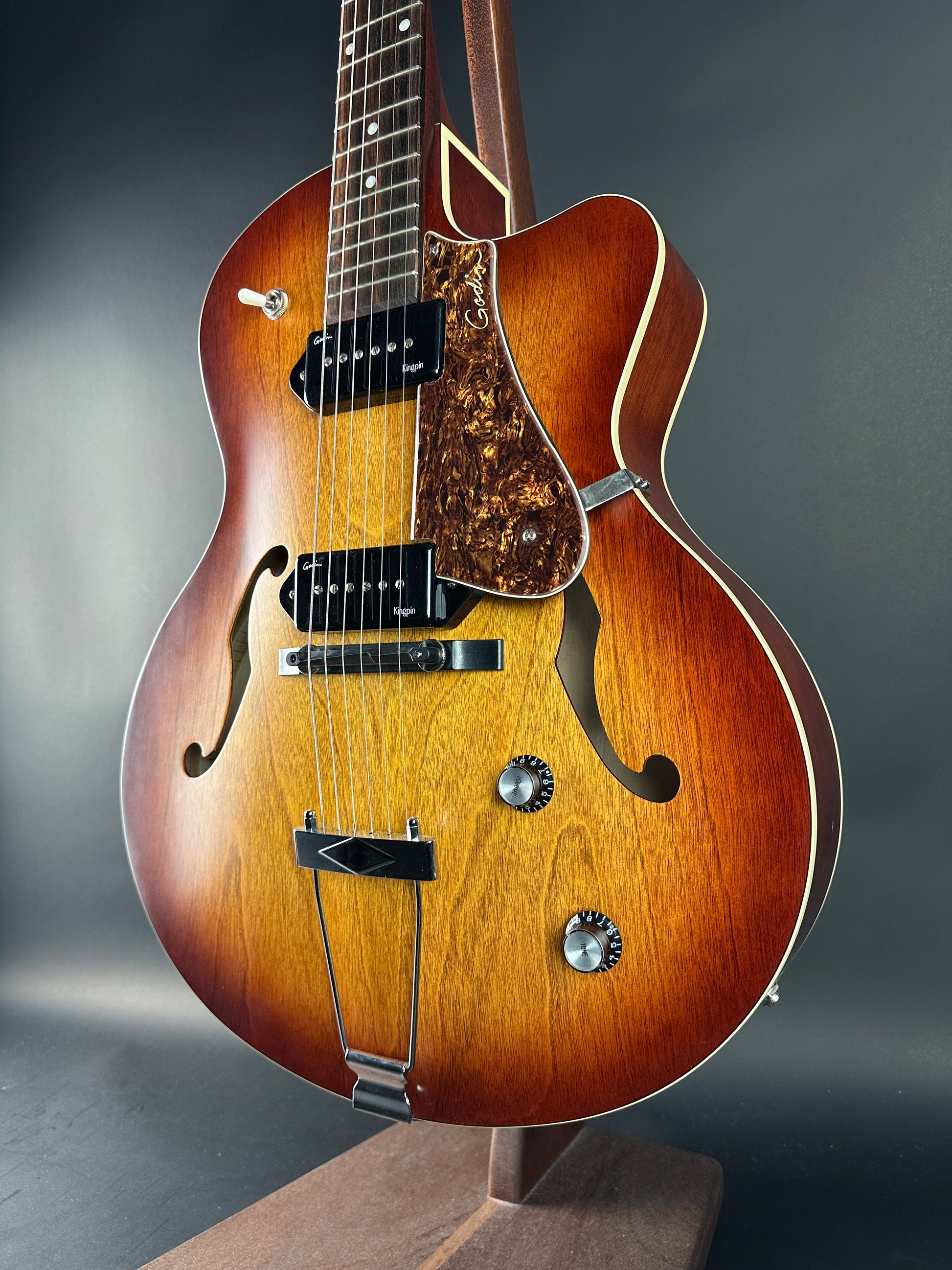 Close-up of a wooden acoustic guitar on a dark background
