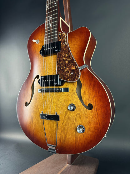 Close-up of a wooden acoustic guitar on a dark background