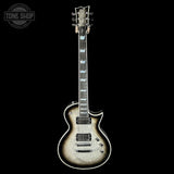 Electric guitar with a black and white color scheme on a black background, featuring the Tone Shop logo.