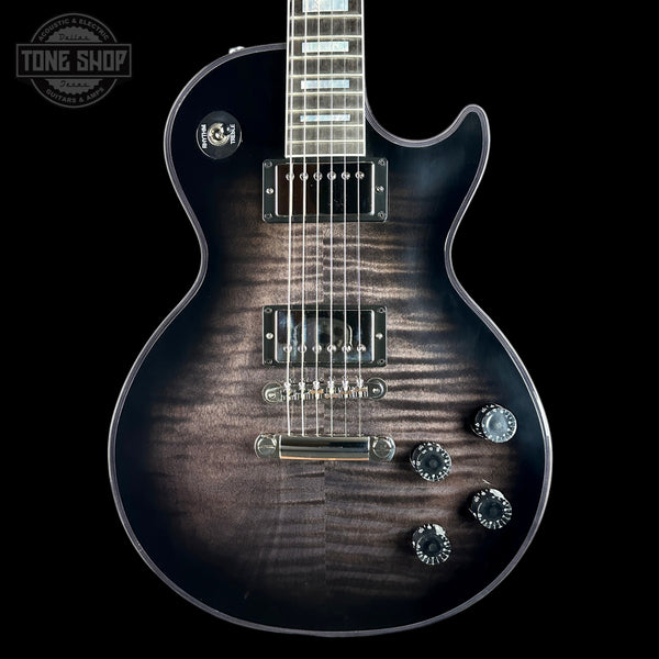 A close-up of an electric guitar body against a black background, showing a dark brown flamed maple wood finish with a black gradient edge. The guitar features chrome hardware, five control knobs, and a visible 'G&H' logo badge on the upper bout.