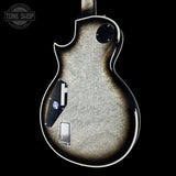 Back view of a guitar with a 'Tone Shop' logo in the corner.