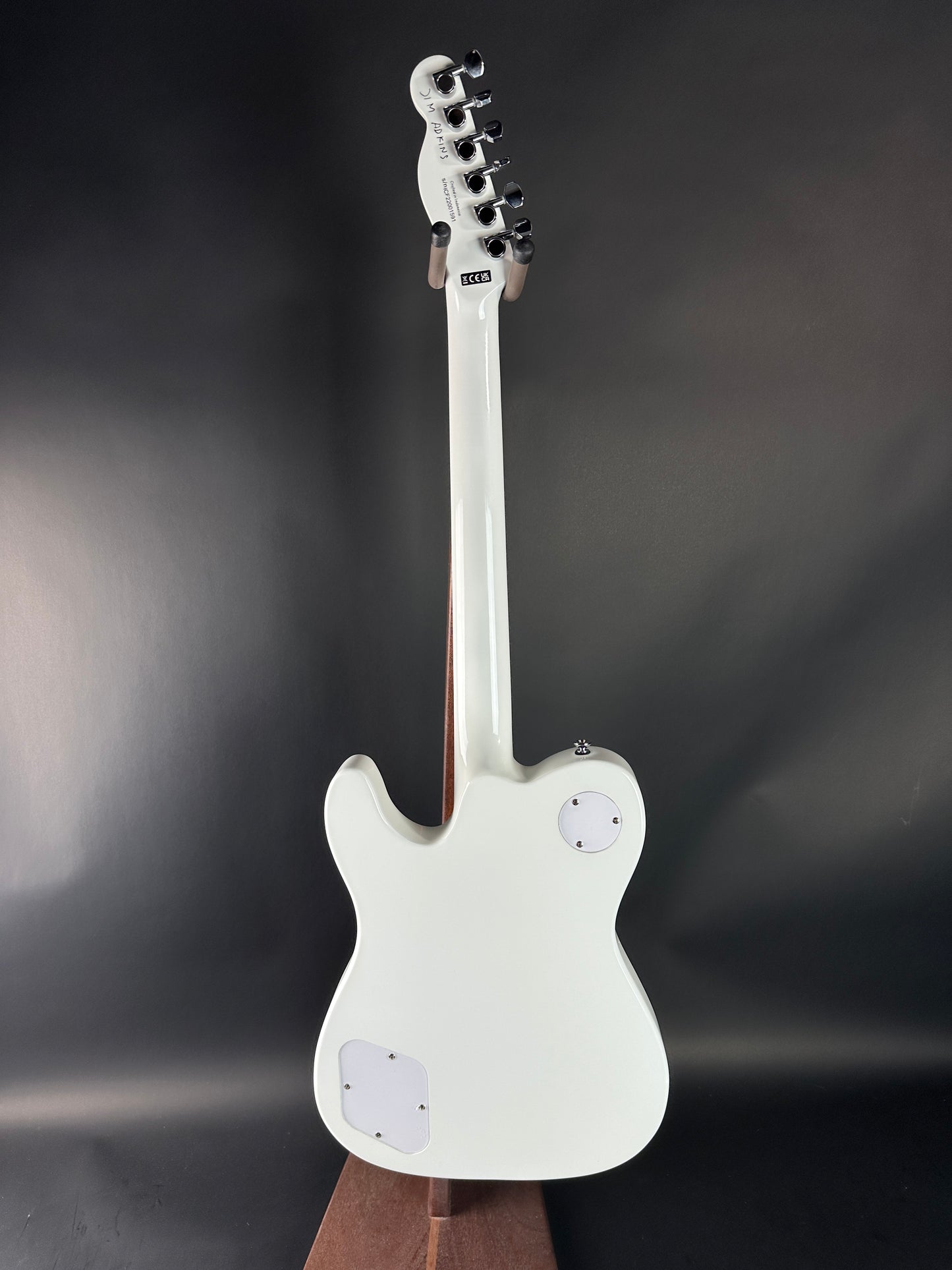 White electric guitar on a dark background