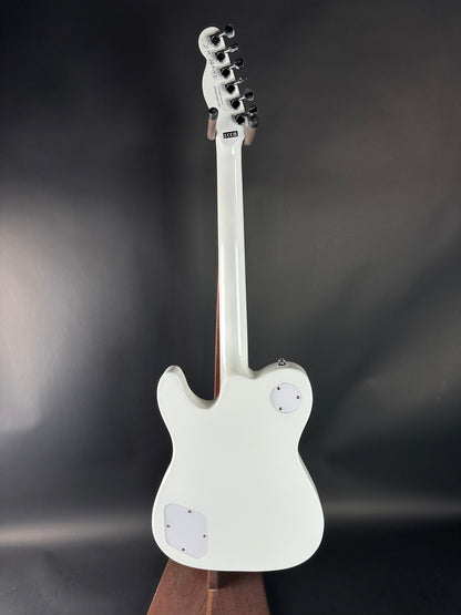 White electric guitar on a dark background