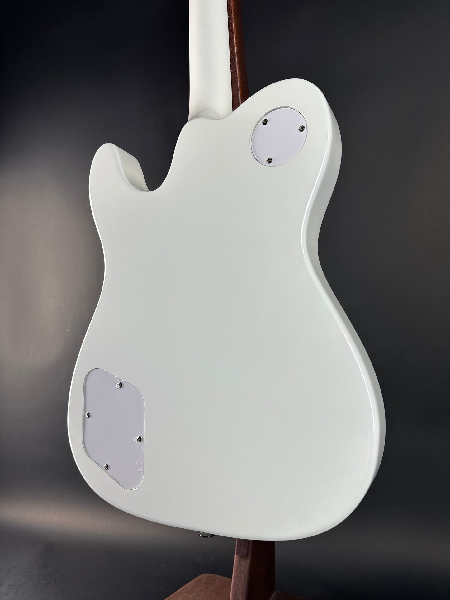 White electric guitar body on a dark background