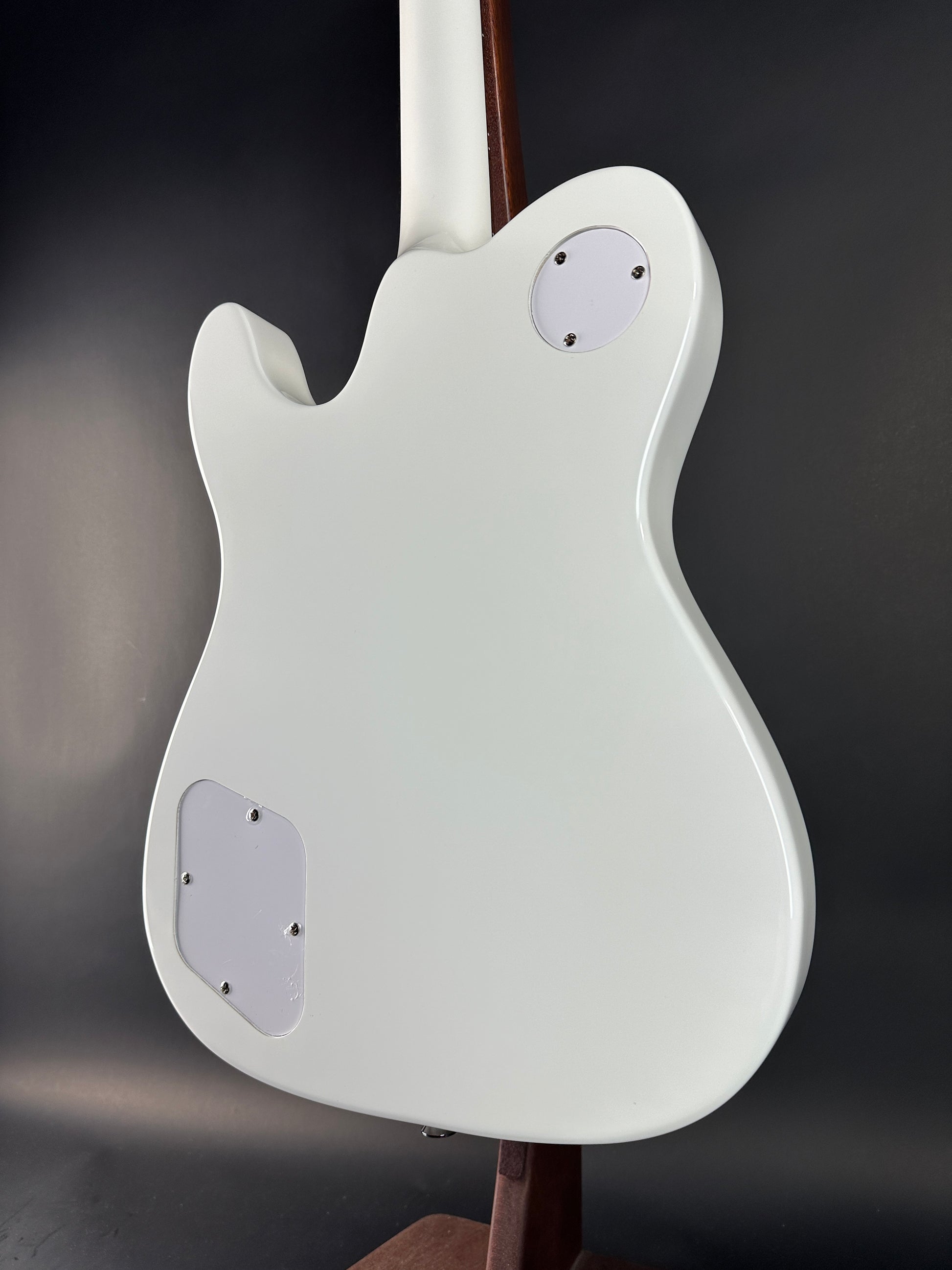 White electric guitar body on a dark background