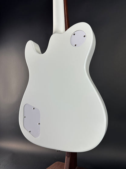 White electric guitar body on a dark background