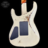 Worn electric guitar body with visible wear and tear on a black background, featuring 'Tone Shop' logo.