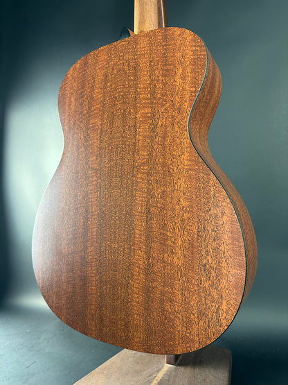 Close-up of a wooden guitar body on a dark background
