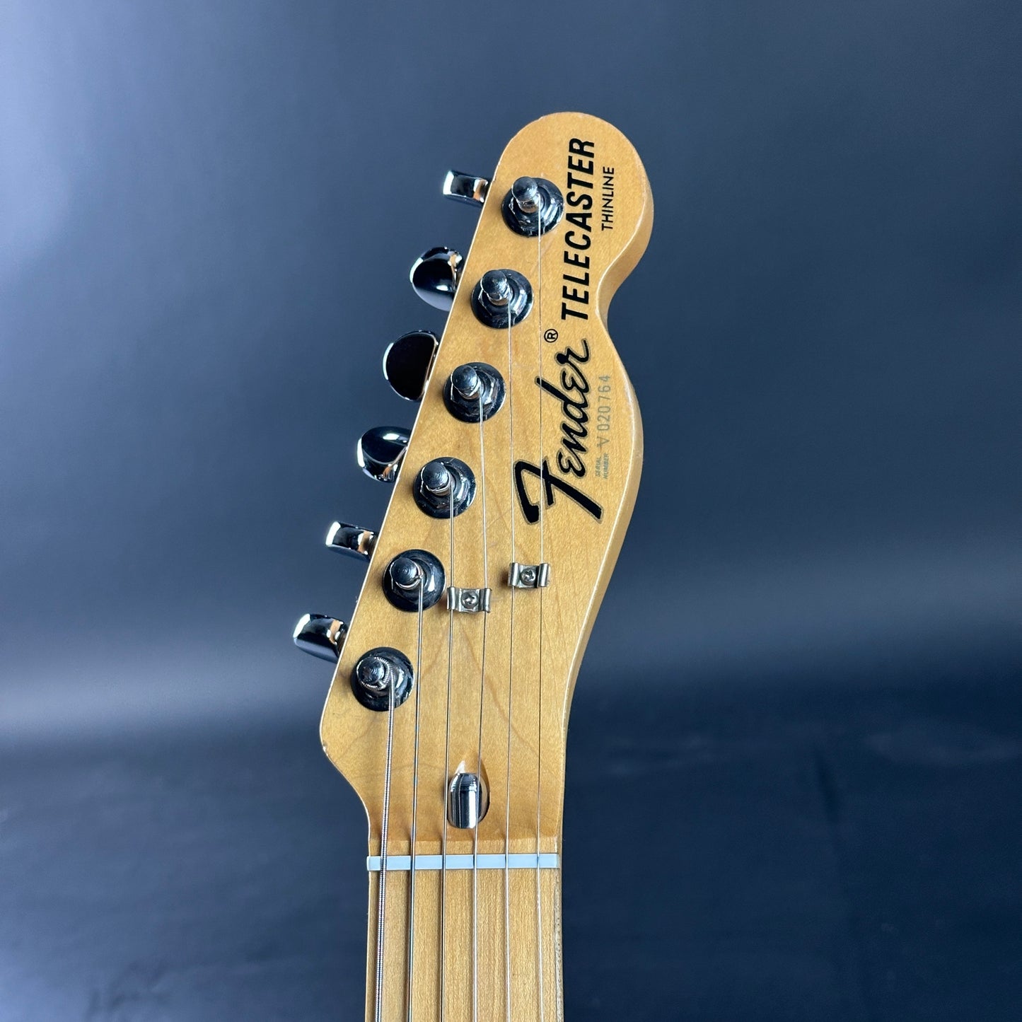 Fender Telecaster guitar headstock on a dark background