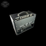 Guitar amplifier with control knobs and connectors on a black background, featuring 'Tone Shop' logo.