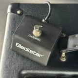 Black electric guitar amplifier with 'Blackstar' branding on a textured surface