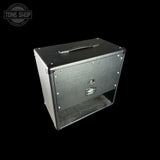 Black guitar amplifier cabinet with 'Tone Shop' logo in the corner.