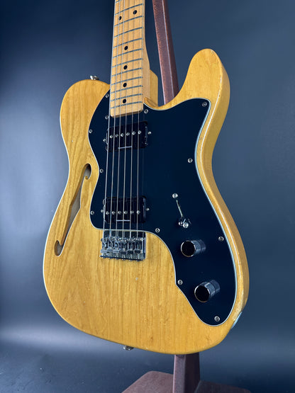 Electric guitar with a blonde finish on a dark blue background