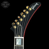 Gibson guitar headstock with brand logo on a black background