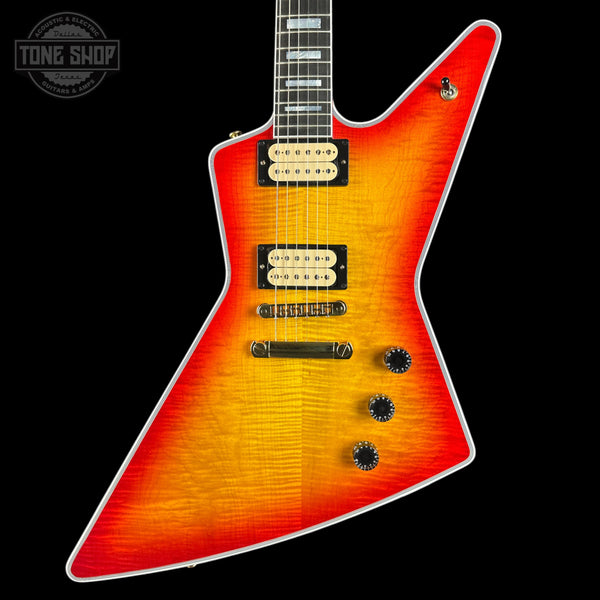 Electric guitar with a sunburst finish on a black background, featuring the Tone Shop logo.