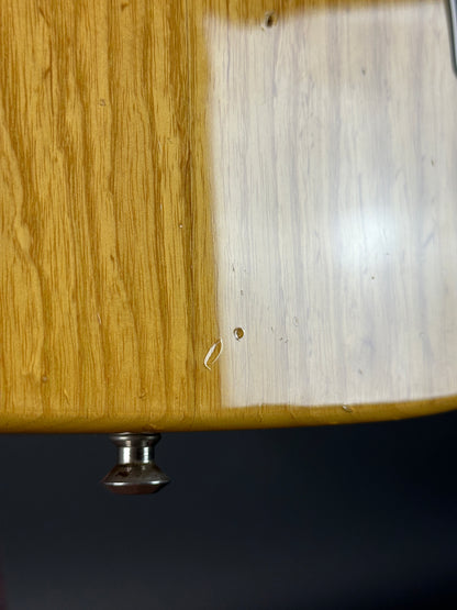 Wooden surface with a metal knob on a dark background