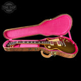 Gibson Les Paul guitar in a pink case with 'Tone Shop' logo.