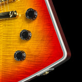 Close-up of a sunburst electric guitar with control knobs on a black background