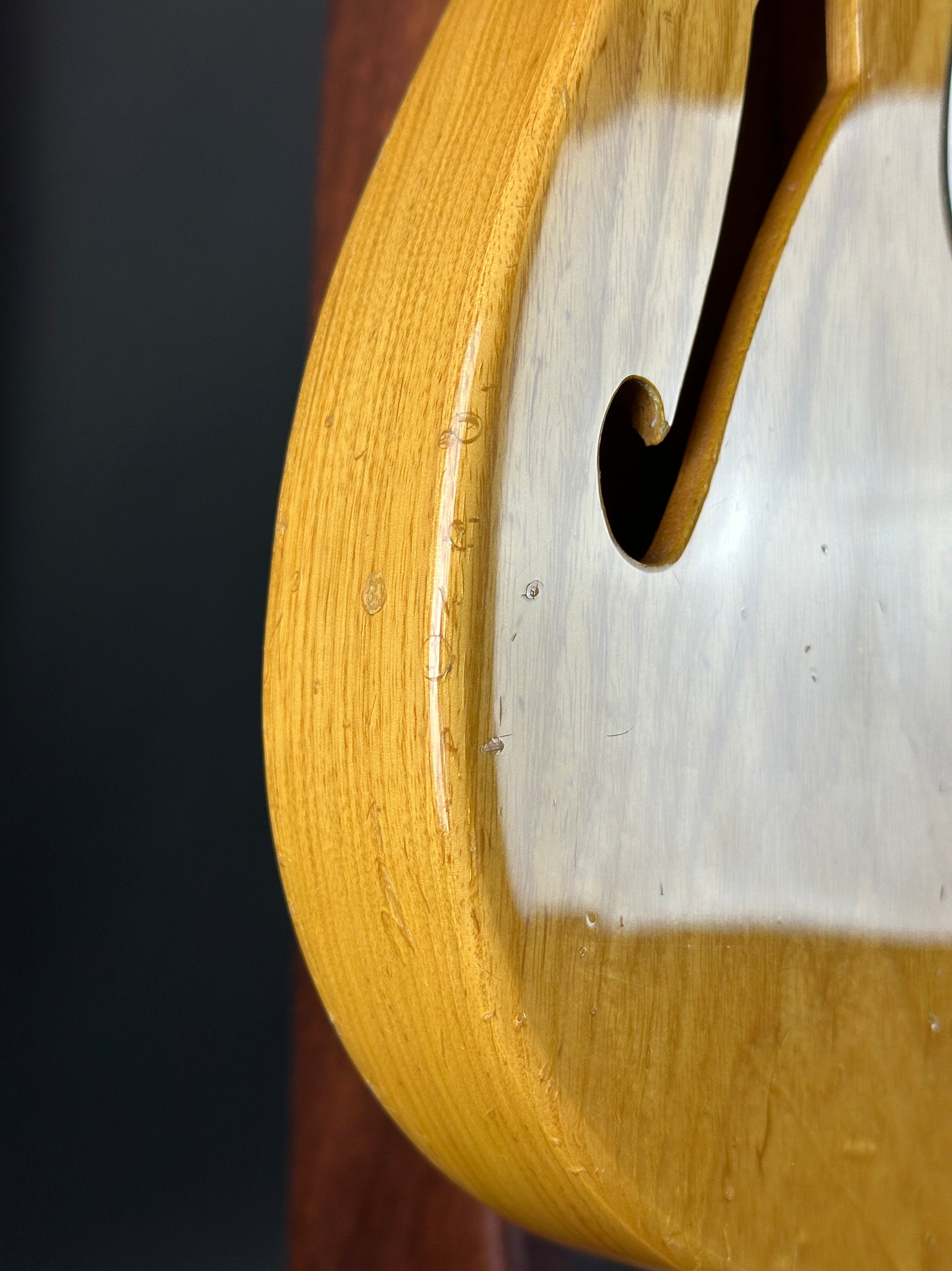 Close-up of a wooden object with a metal component on a dark background