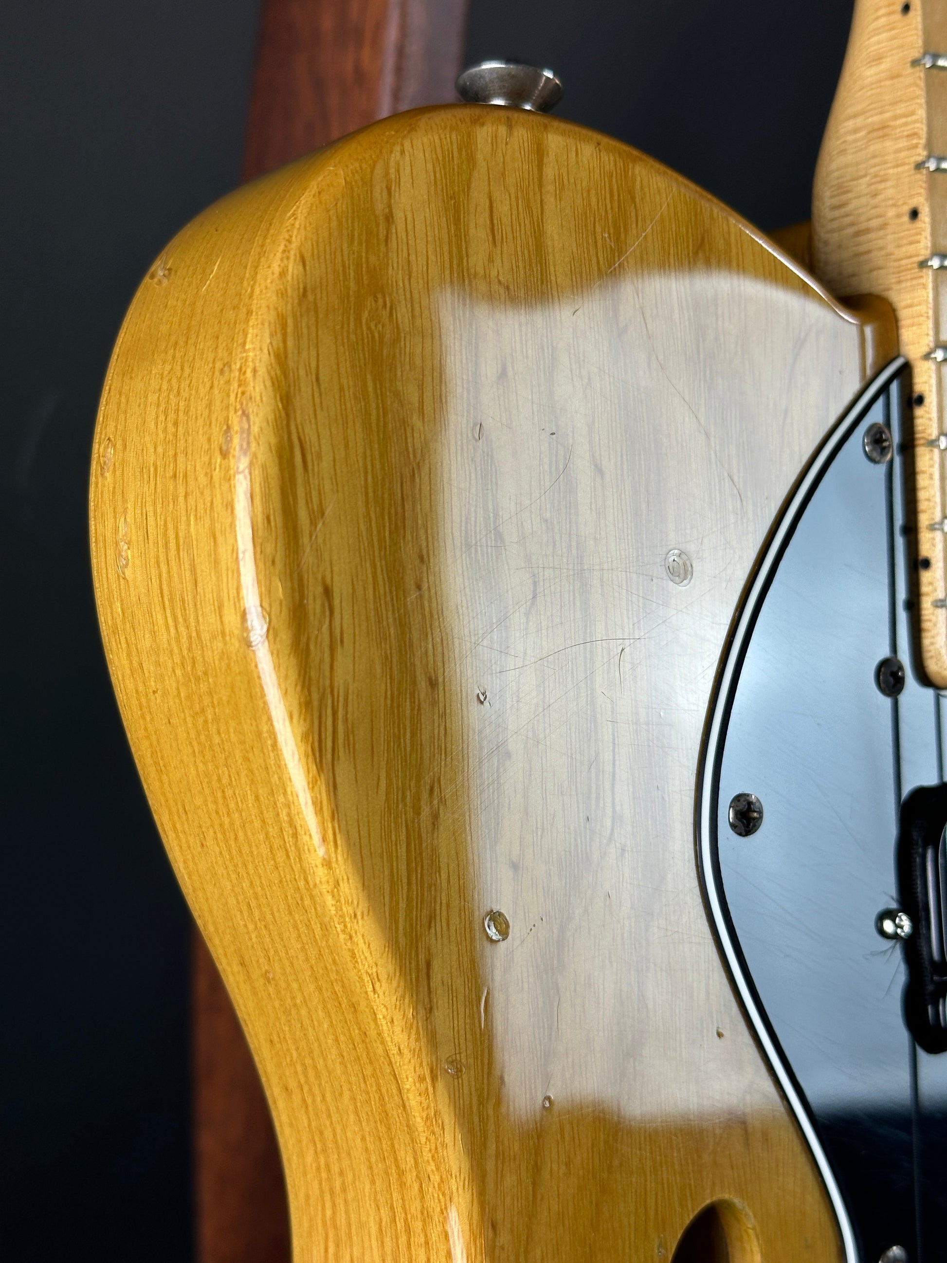 Close-up of a guitar's wooden neck and headstock