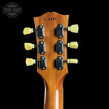 Guitar headstock with tuning pegs on a black background, featuring 'Tone Shop' logo.